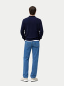 back view of a man wearing a navy sweater and blue jeans on a white background. #color_navy #ai-image