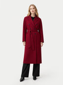 Woman wearing a red coat on a white background. #color_bordeaux #ai-image