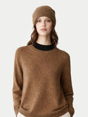 Woman wearing a brown sweater and matching beanie on a white background #color_lead-gray