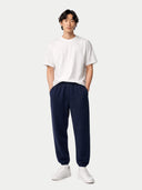 Person wearing a white t-shirt and navy pants on a white background. #color_ink-blue #ai-image