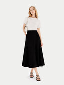 Woman wearing a white top and black skirt on a white background. #color_black #ai-image