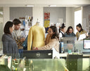 GOBI's e-commerce team gathered around a laptop in the design office