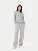 Person wearing a gray outfit on a white background
