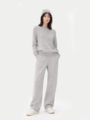 Person wearing a gray outfit on a white background #color_light-gray