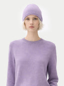Person wearing a light purple sweater and matching beanie against a white background #color_purple-ash