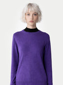 Person wearing a purple sweater on a white background. #color_dusty-grape #ai-image