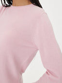 close up of a soft pink crew neckline sweater. #color_pink